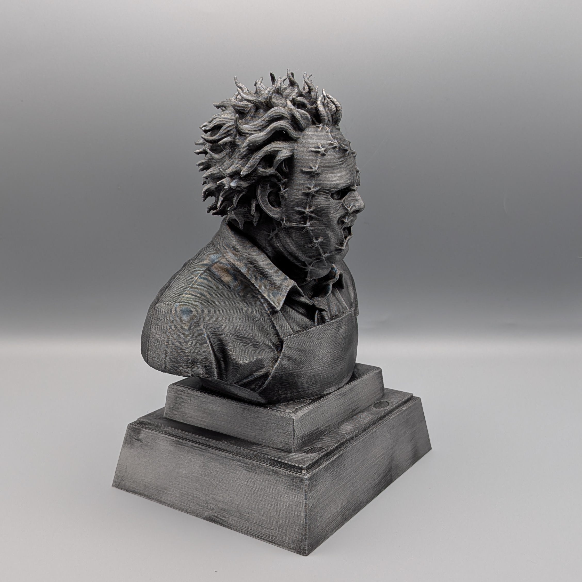 Right-hand side view of the hand-painted silver Leatherface tribute bust with detailed mask and costume textures