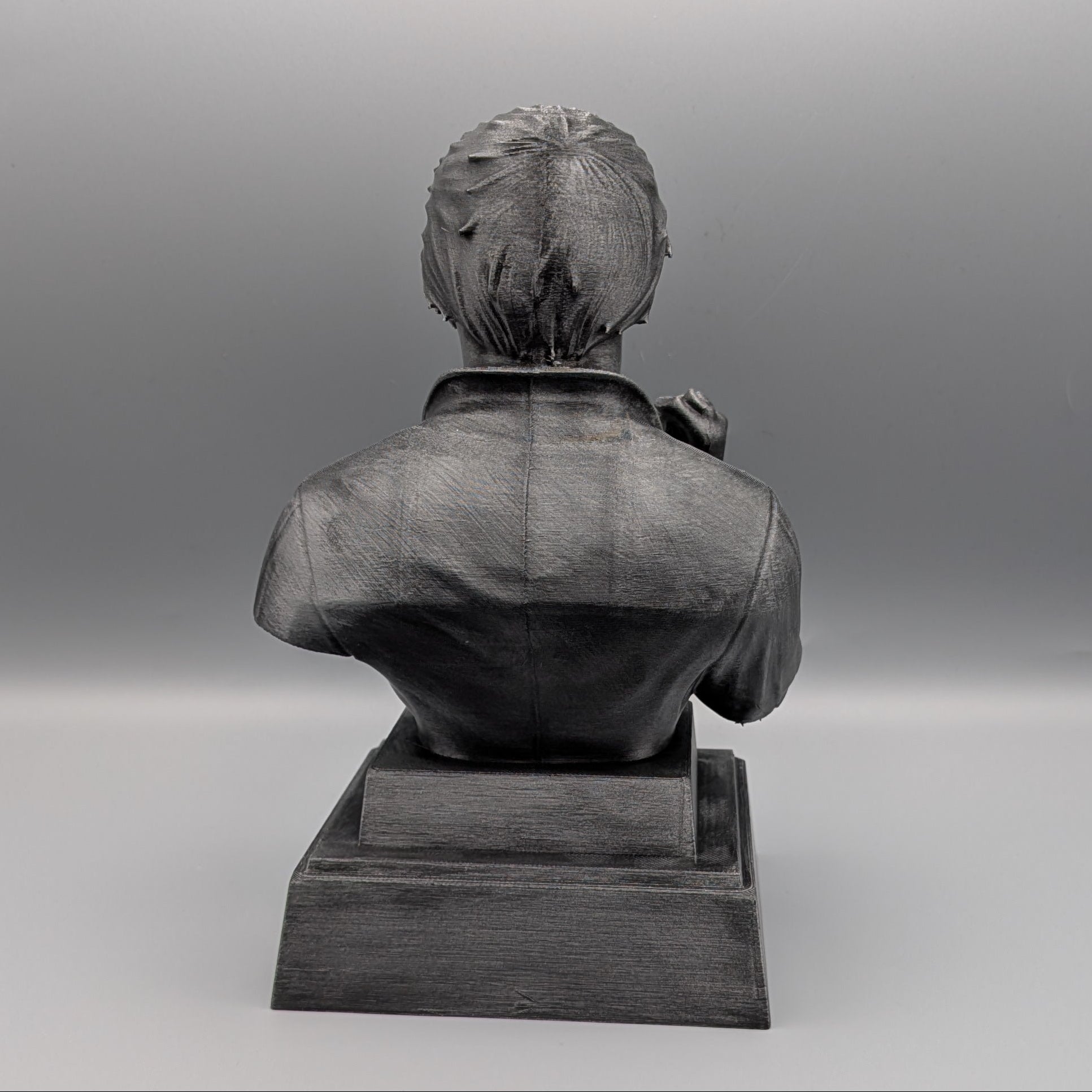 Back view of the silver Michael Myers tribute bust showing the sculpted hair, overalls and pedestal base