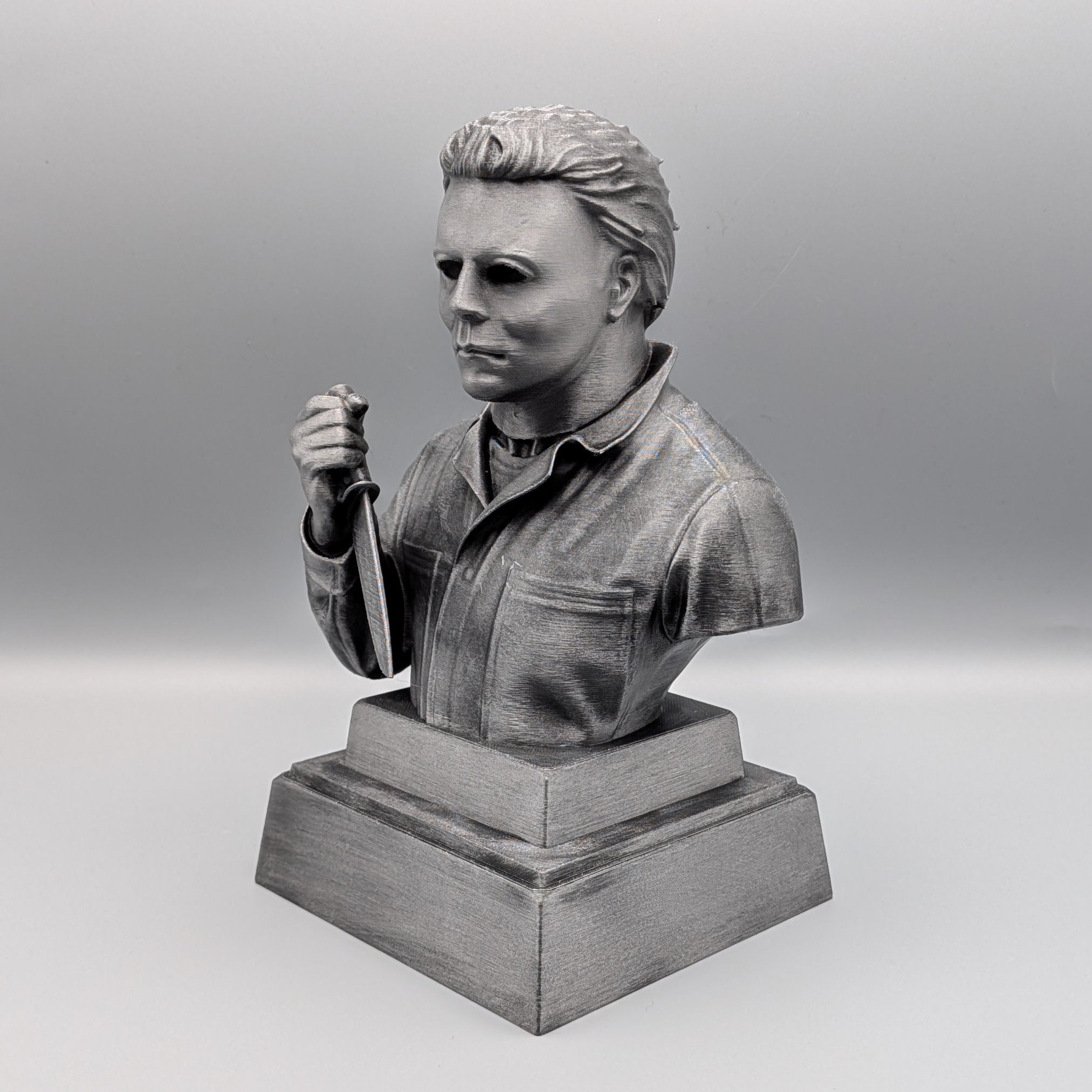 Left-hand side view of the hand-painted Michael Myers tribute bust showing the mask, knife and silver finish