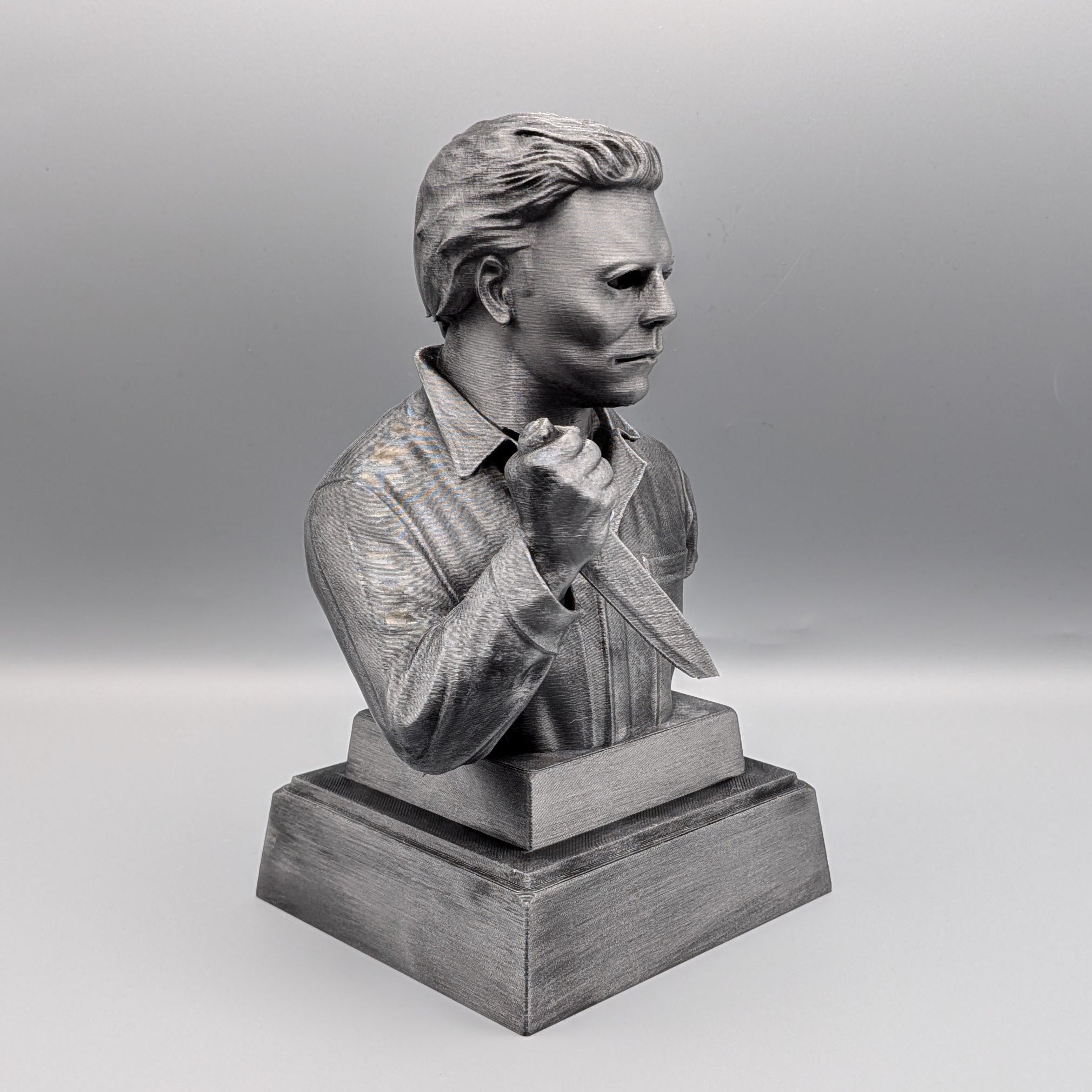 Right-hand side view of the hand-painted Michael Myers tribute bust holding a knife on a solid pedestal base