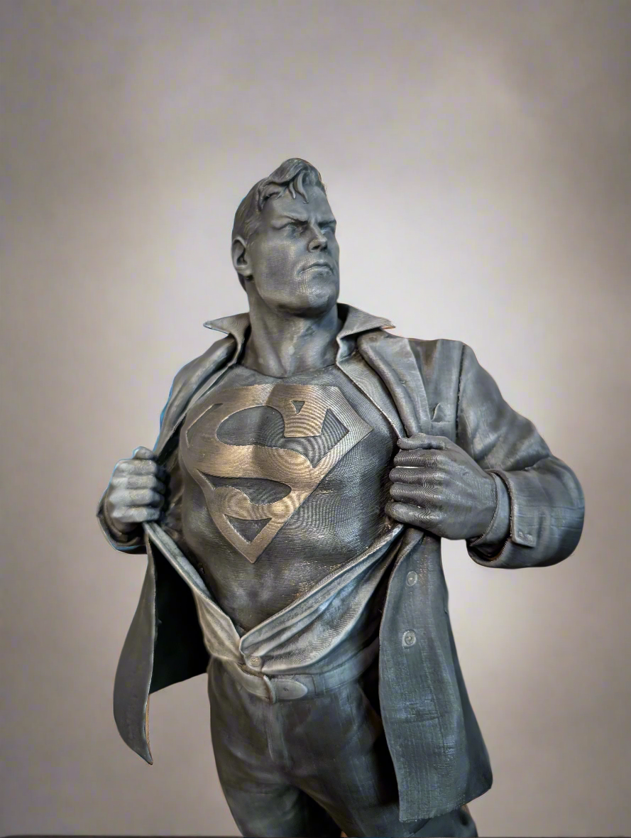 Statue of a superhero with a visible Superman logo on a plain background