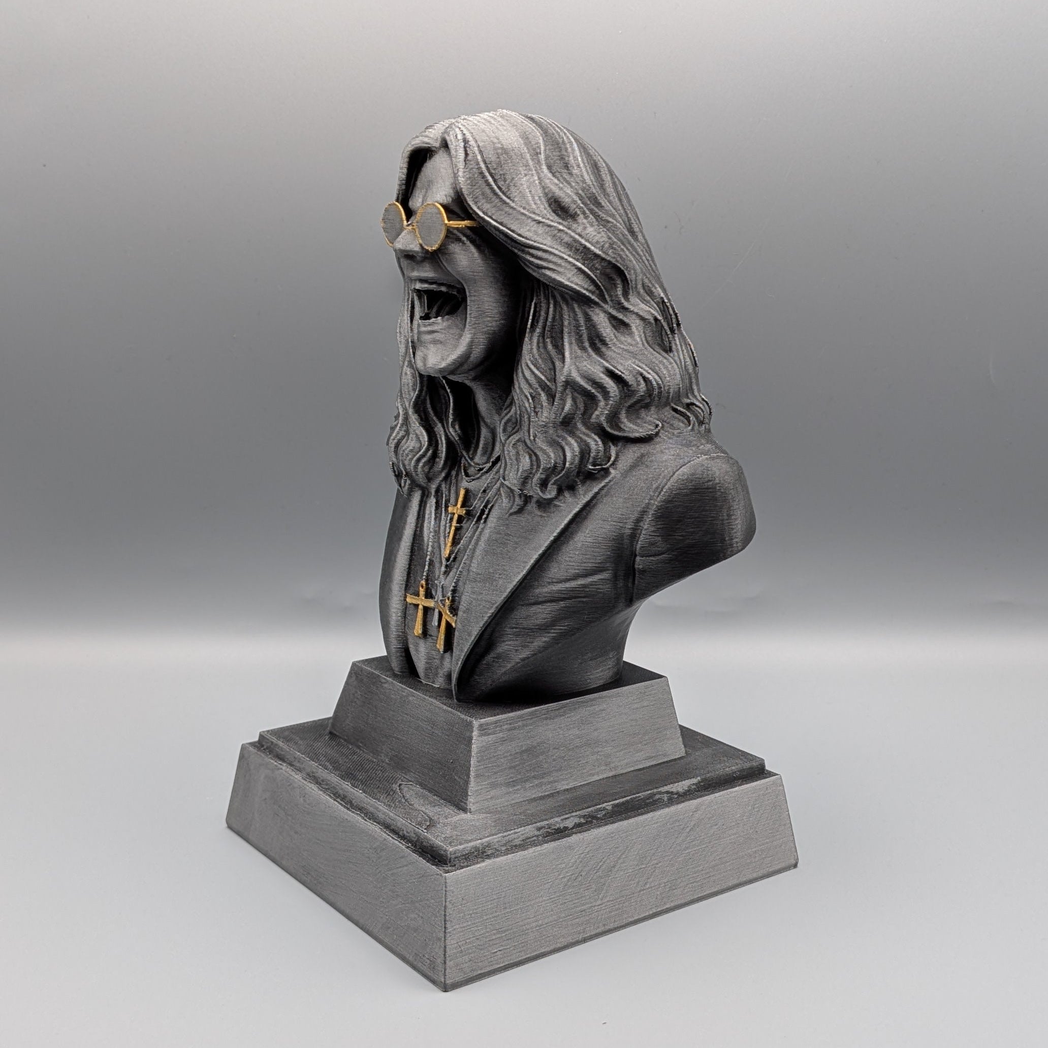 Rock Legend Tribute Bust inspired by Ozzy, detailed rock icon sculpture with gold glasses and crosses – angled view