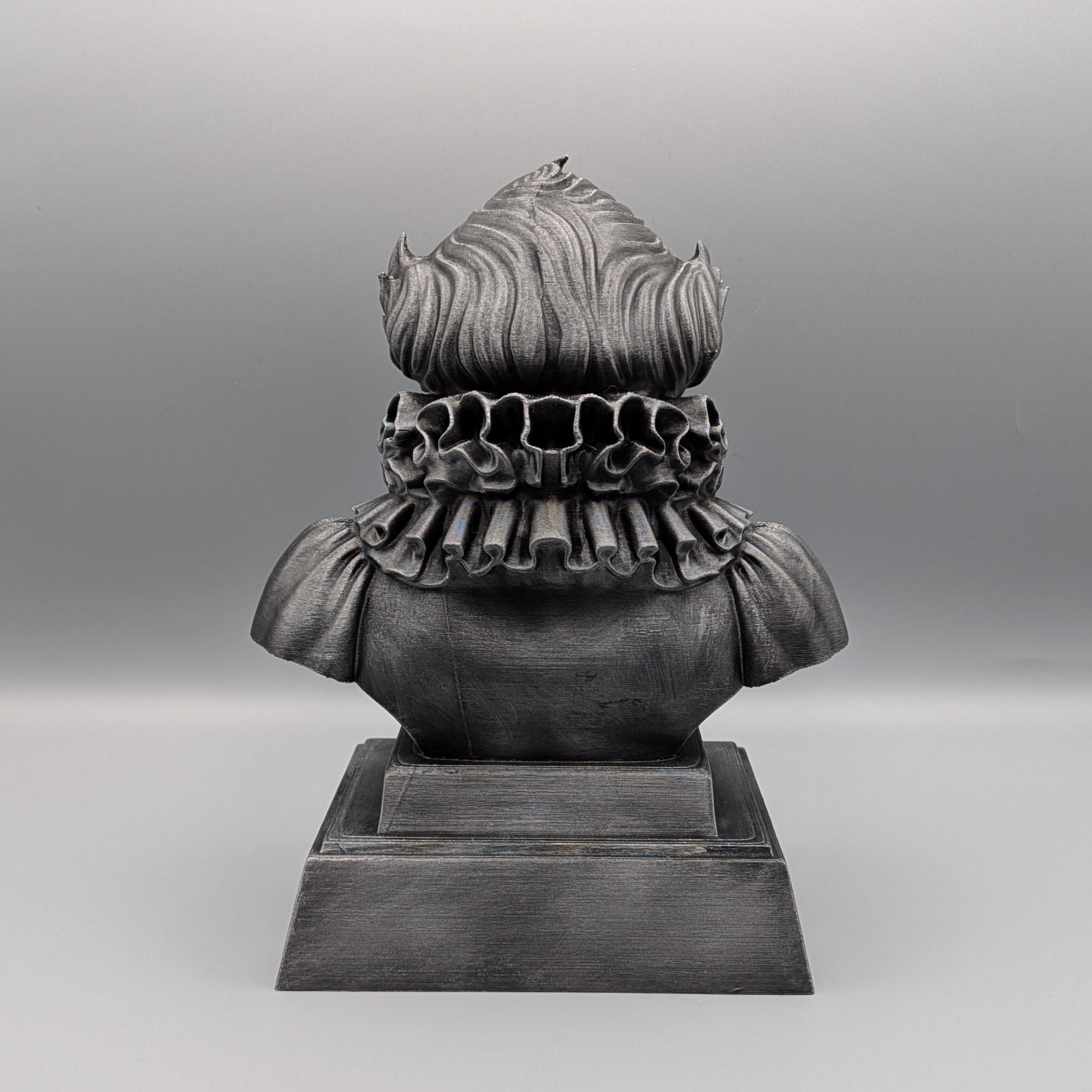 Back view of the silver Pennywise tribute bust showing the sculpted hair, ruffled collar and pedestal base