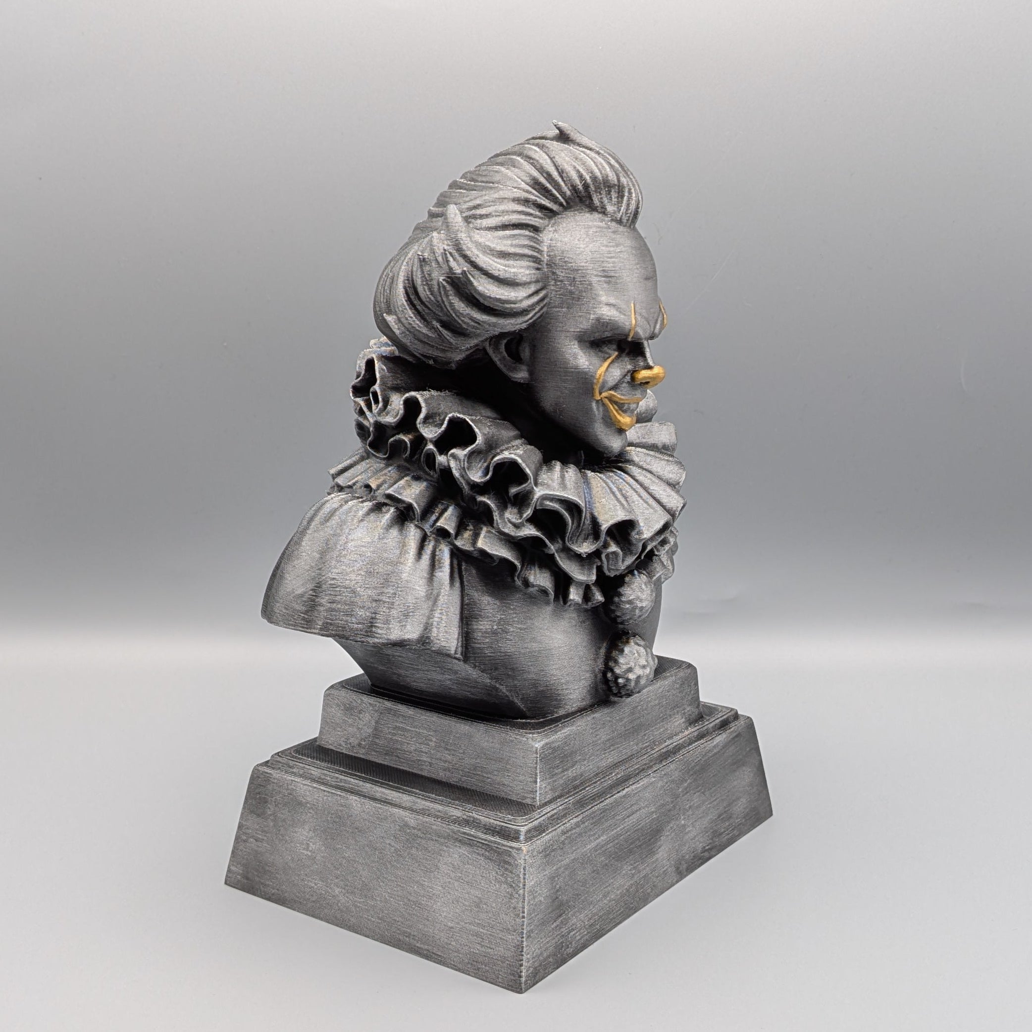 Right-hand side view of the hand-painted Pennywise tribute bust showing the profile, ruffled costume and pedestal base