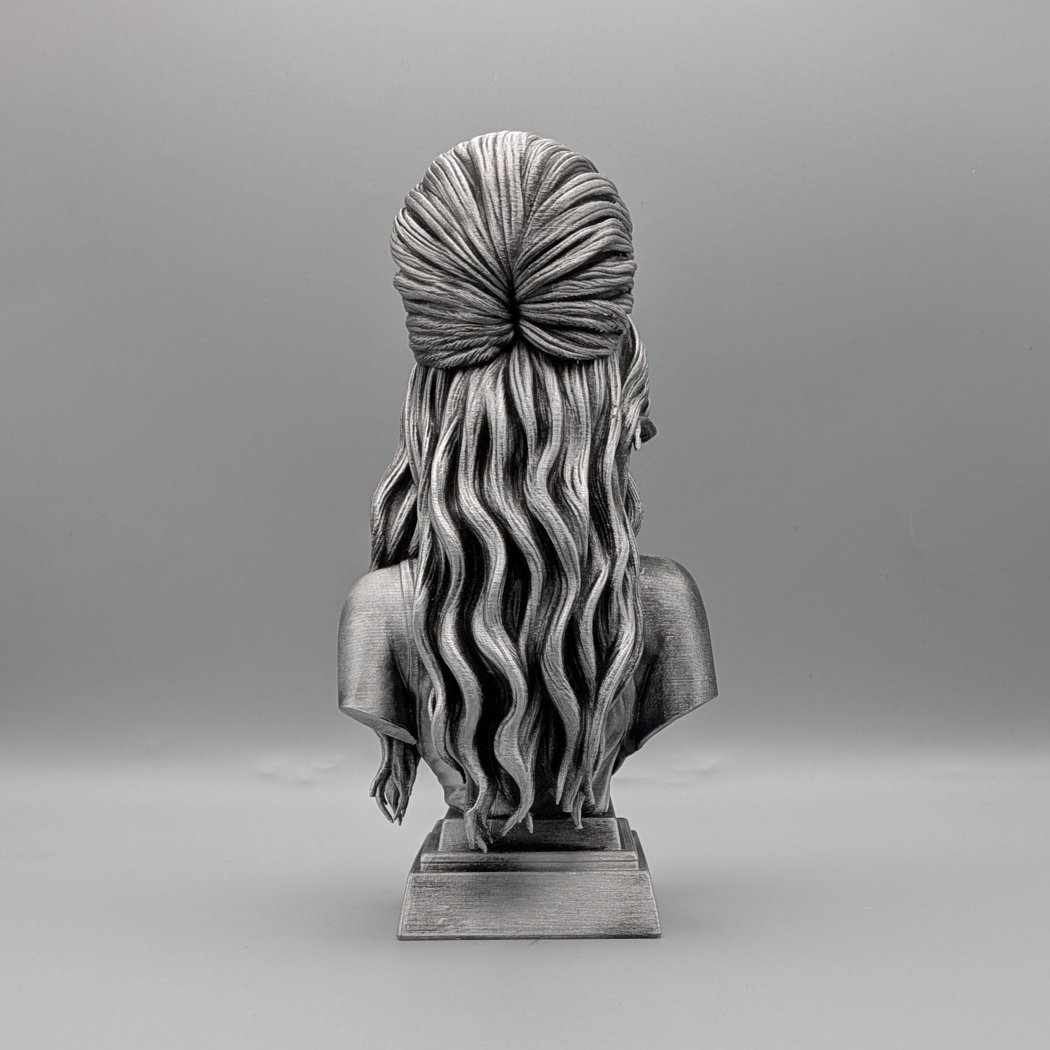 Rear view of tribute bust showing sculpted hair and silhouette
