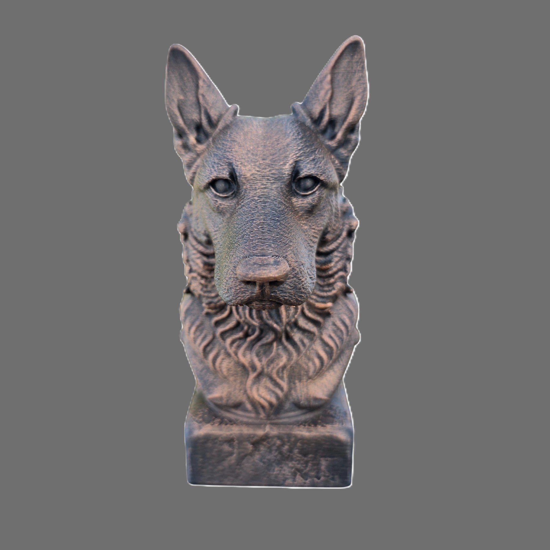 A sculpted dog bust statue with a metallic bronze finish, set against a solid gray background.