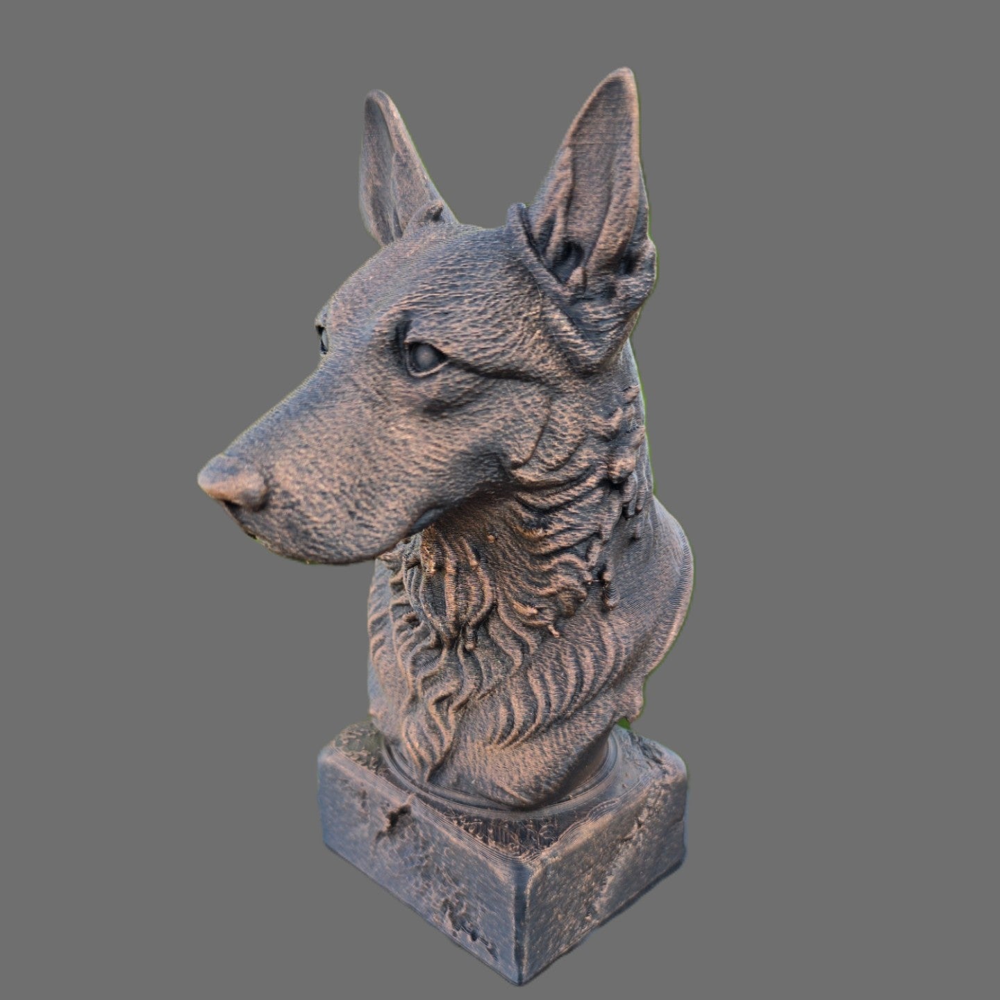 A decorative dog bust sculpture in a bronze textured finish, shown on a solid gray background.