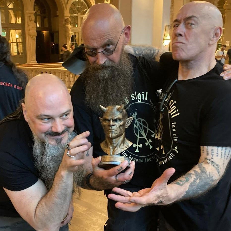 Venom Inc. band members posing with the official Venom Inc. Mascot Bust collectible