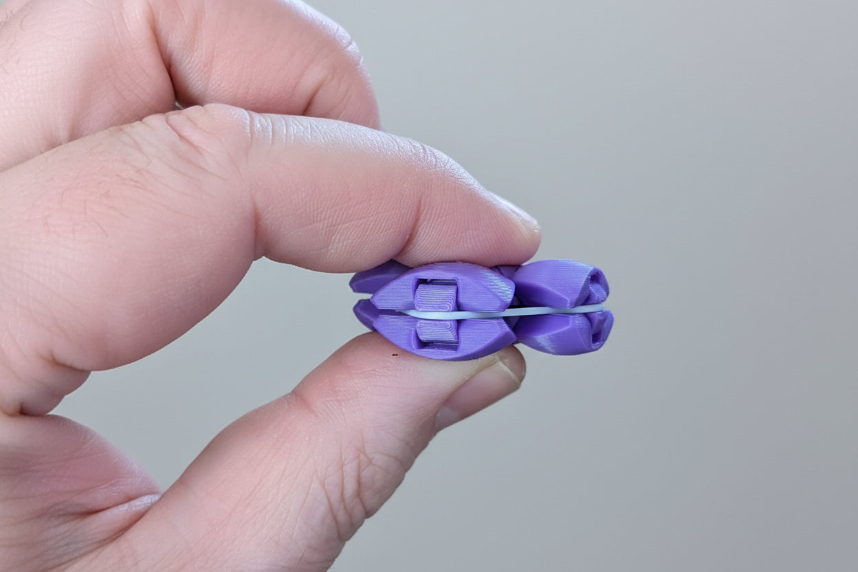 Zorble fidget toy being squeezed showing squishy snap motion